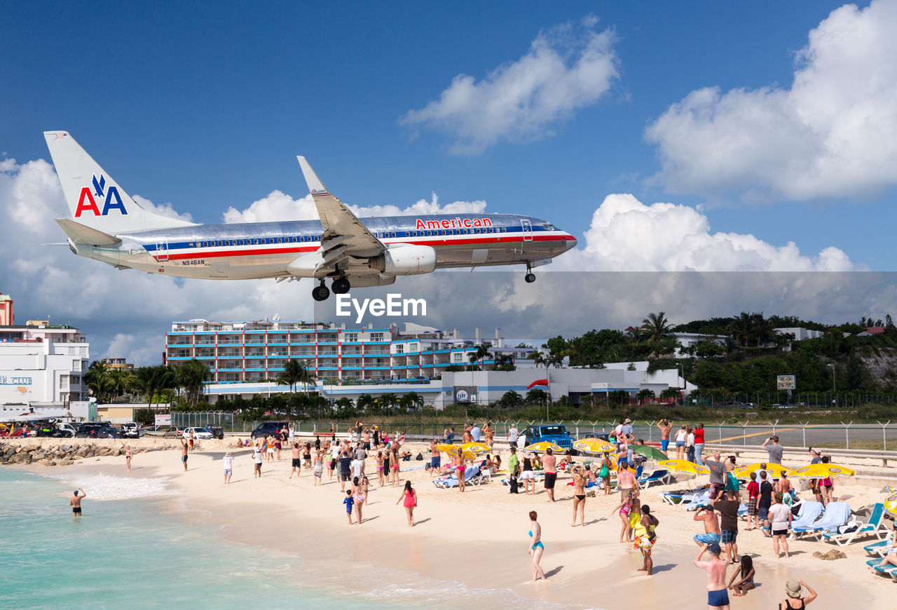 GROUP OF PEOPLE ON AIRPLANE FLYING OVER LAND