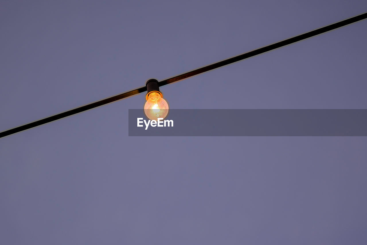 LOW ANGLE VIEW OF LIGHT BULBS AGAINST CLEAR SKY