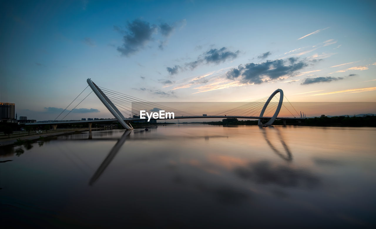 SILHOUETTE BRIDGE AGAINST SKY DURING SUNSET