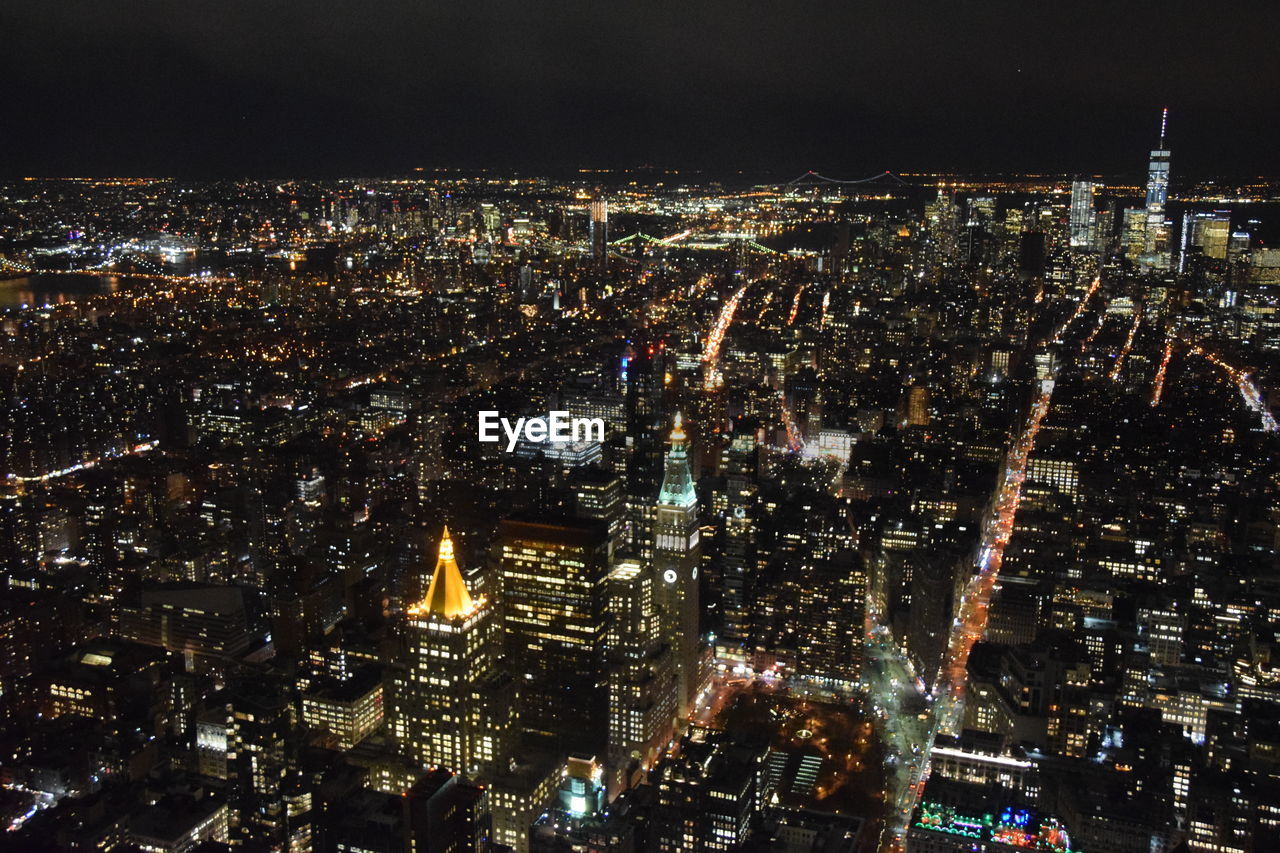 AERIAL VIEW OF ILLUMINATED CITYSCAPE