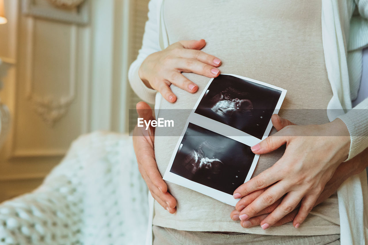 Midsection of woman using mobile phone