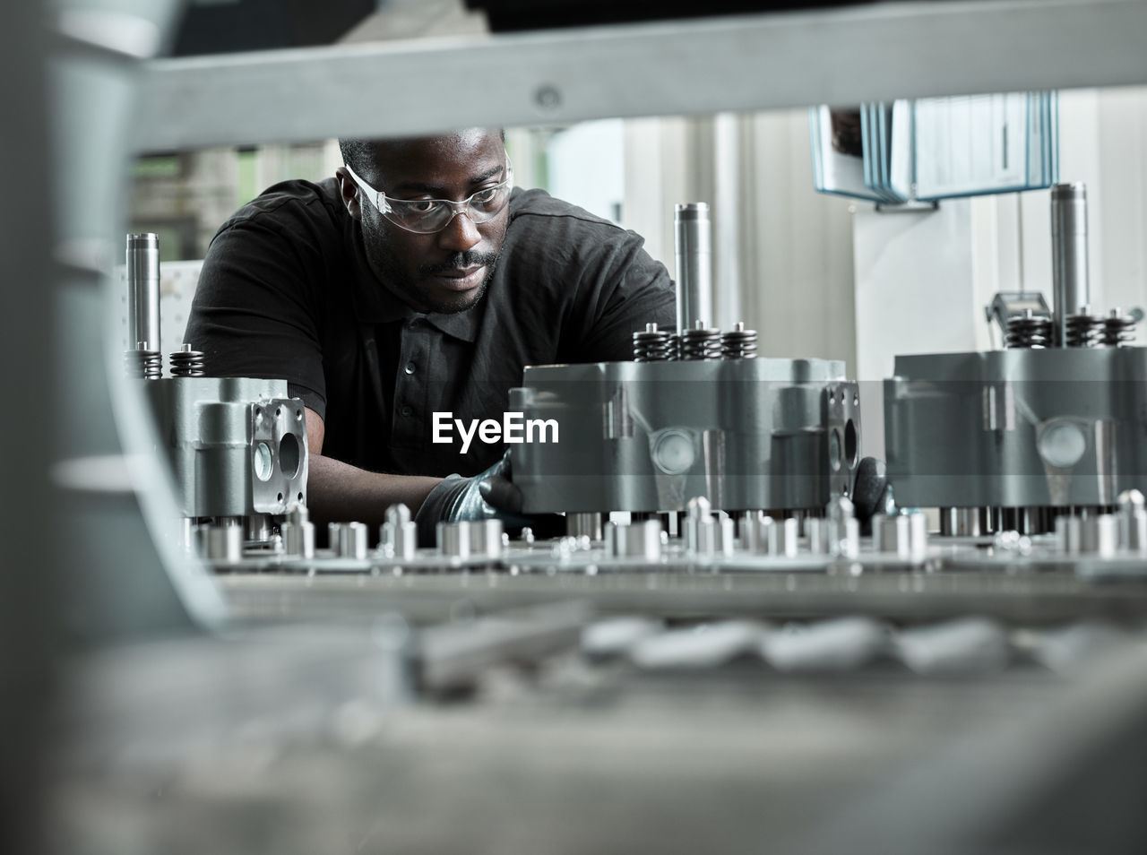 Young man checking production line on a conveyor belt