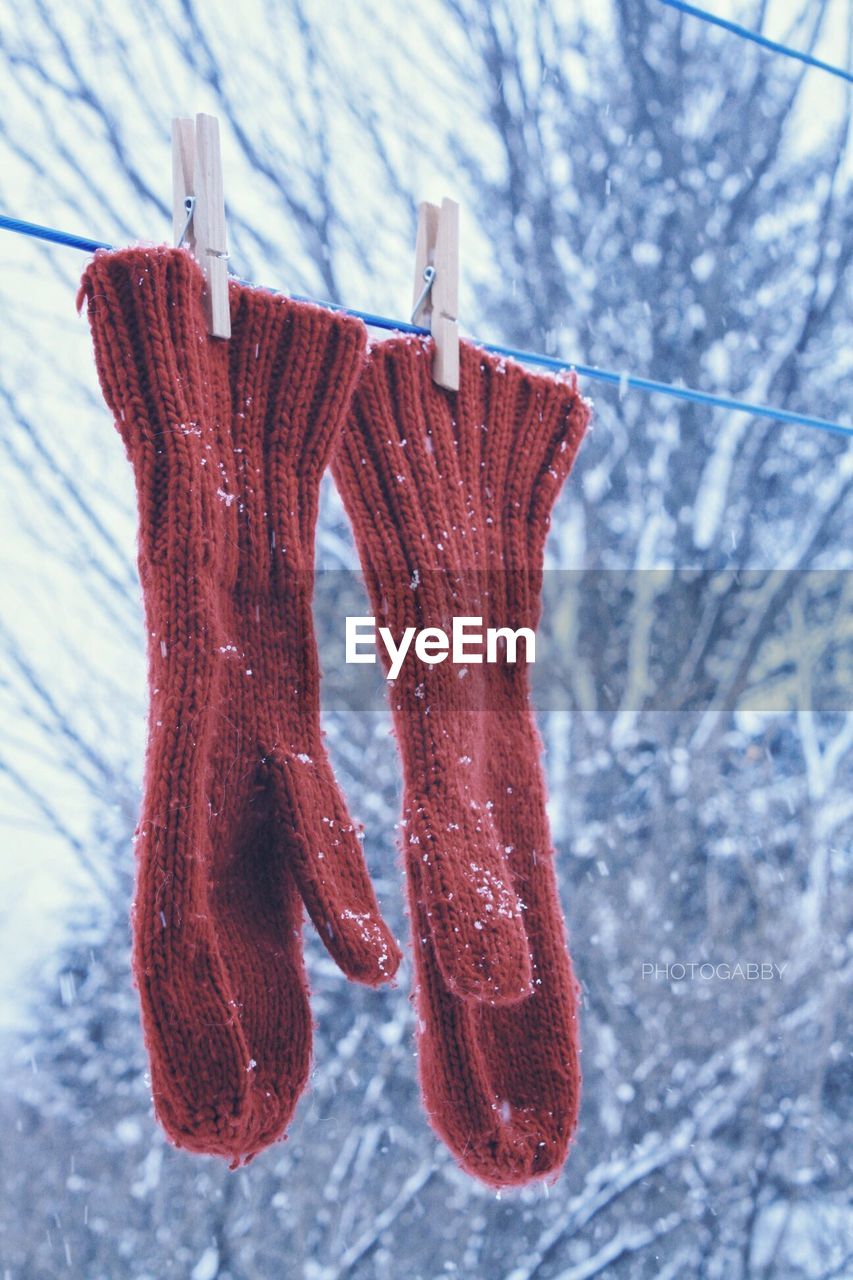 CLOSE-UP OF CLOTHES DRYING ON SNOW COVERED