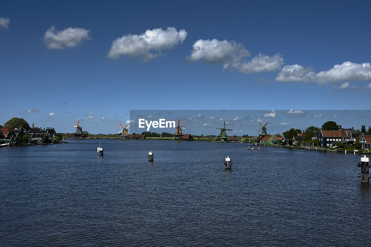 water, sky, architecture, sea, cloud, shore, built structure, nature, city, travel destinations, horizon, body of water, travel, building exterior, transportation, blue, nautical vessel, building, bay, tourism, coast, scenics - nature, no people, environment, outdoors, day, beauty in nature, waterfront, landscape, dusk, land, trip, vacation, holiday, beach, harbor, vehicle, tranquility, cityscape, mode of transportation, reflection
