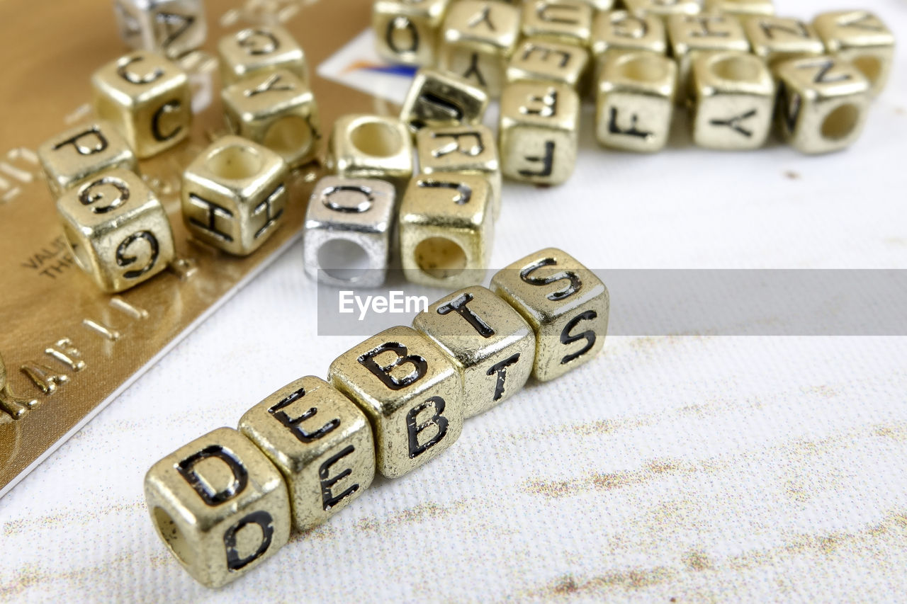 HIGH ANGLE VIEW OF TEXT ON TABLE AT CAFE