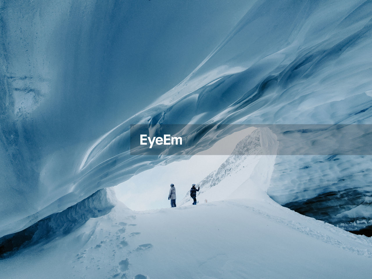 People in ice snowcapped cave