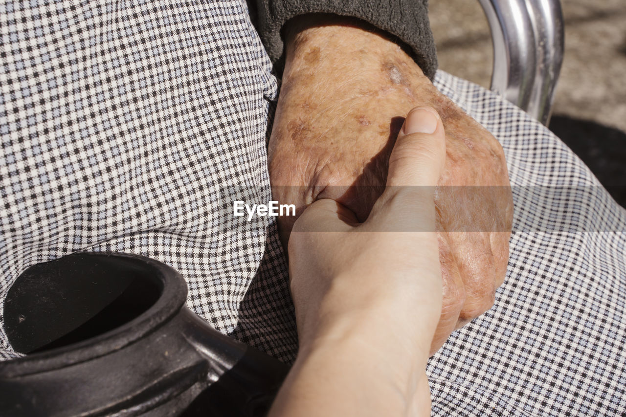 Close-up of people holding hands