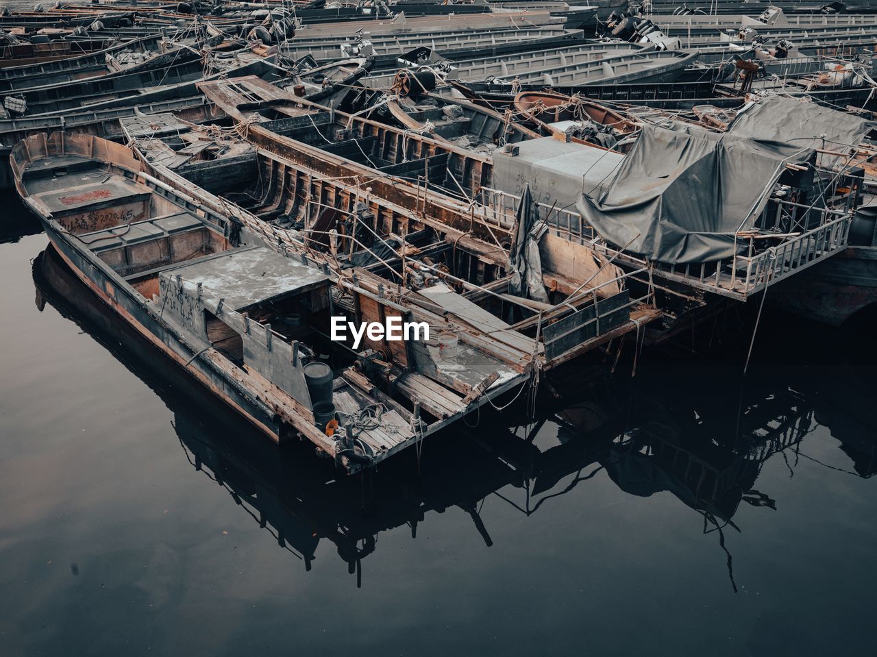 HIGH ANGLE VIEW OF FISHING BOATS MOORED IN HARBOR