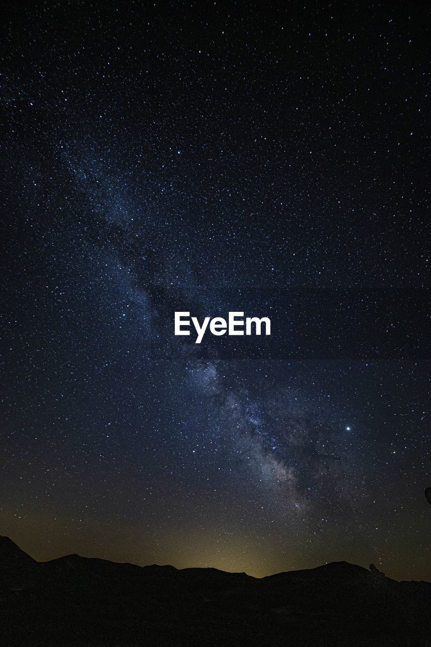 Scenic view of star field against sky at night