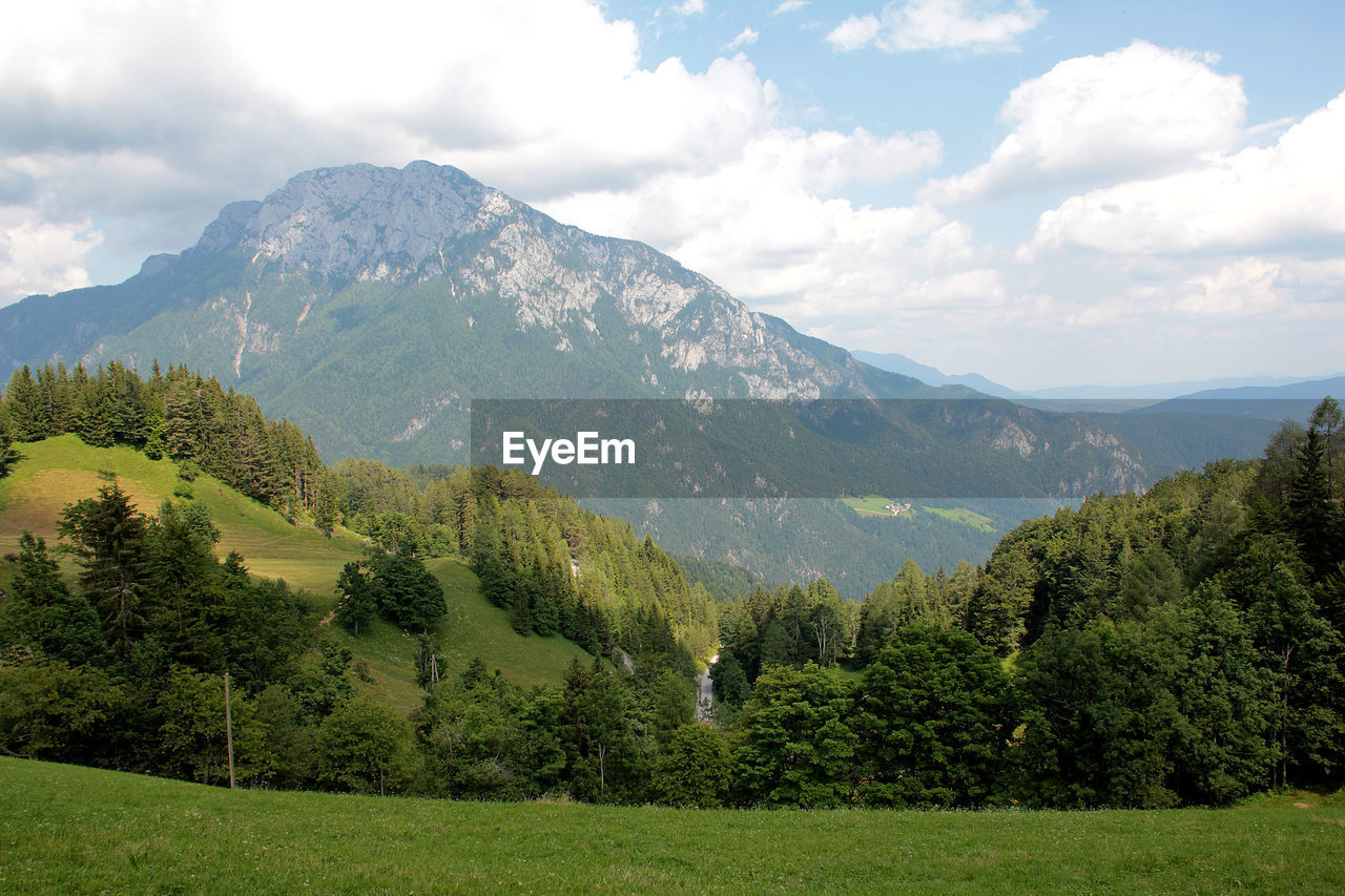 Scenic view of mountains against cloudy sky