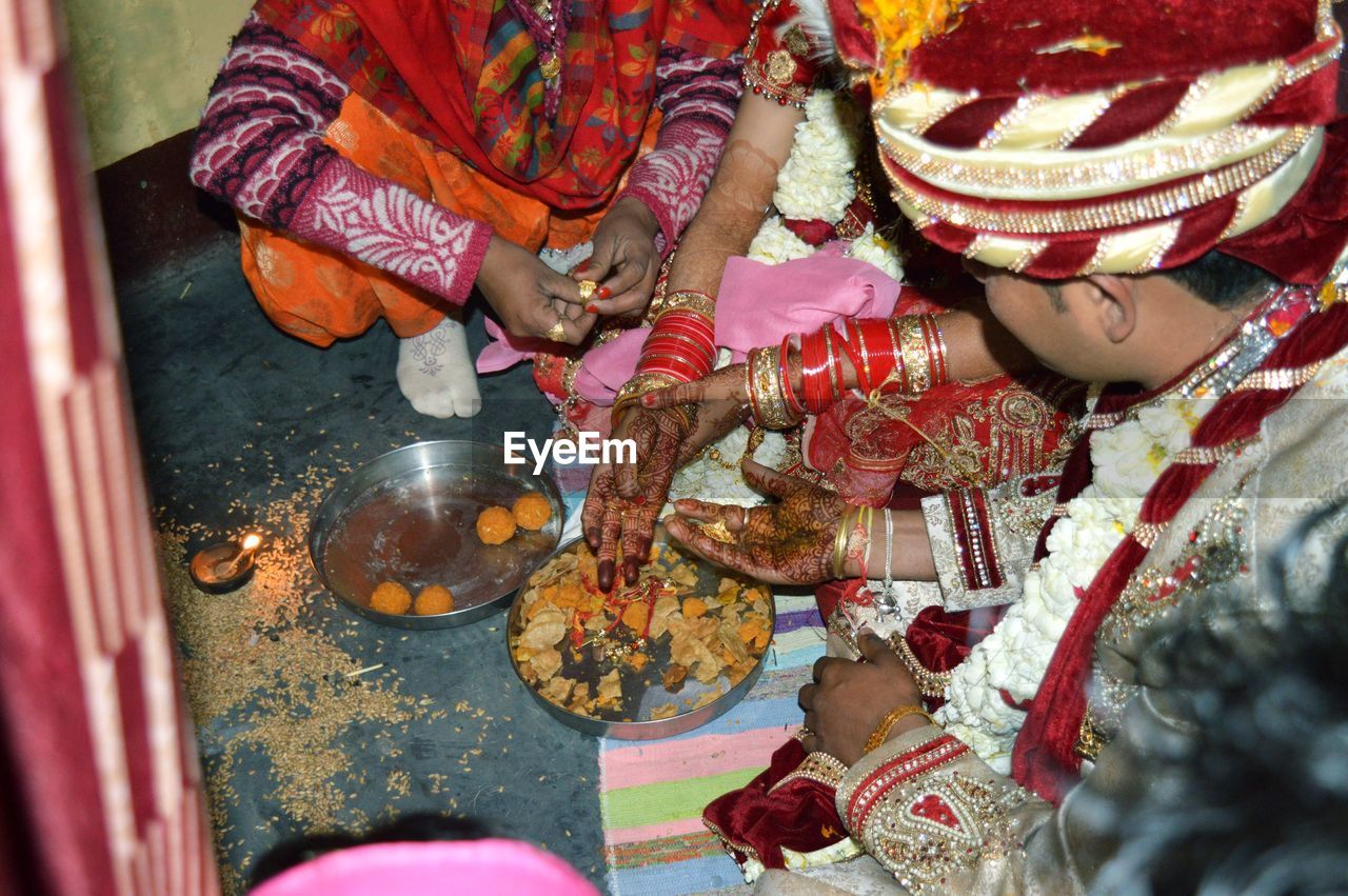 Midsection of couple in wedding ceremony