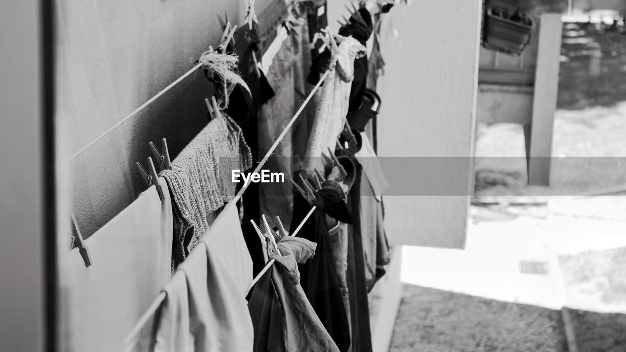 Close-up of clothes drying on clothesline against wall