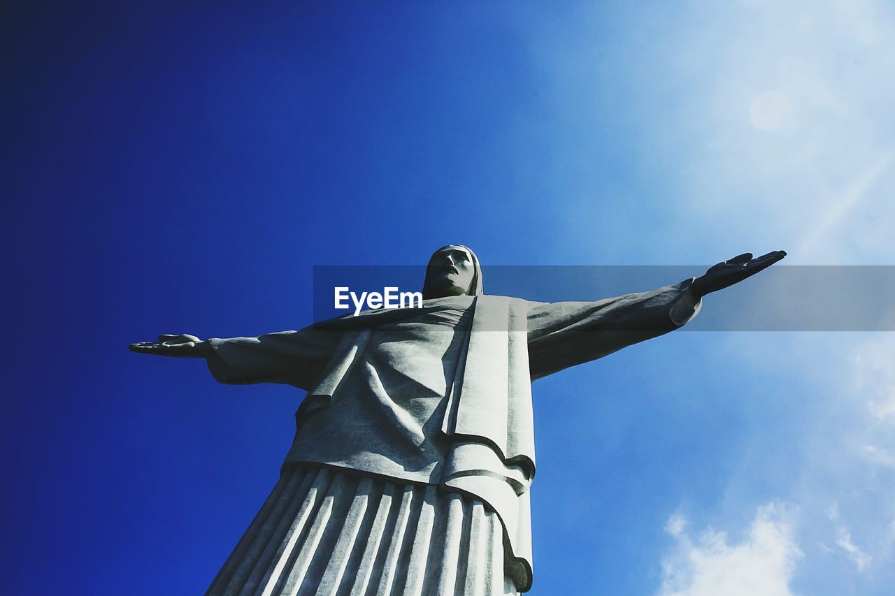 Low angle view of christ the redeemer against blue sky