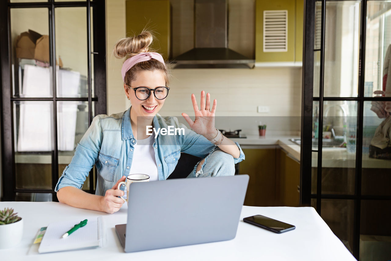 Woman talking on video call at home