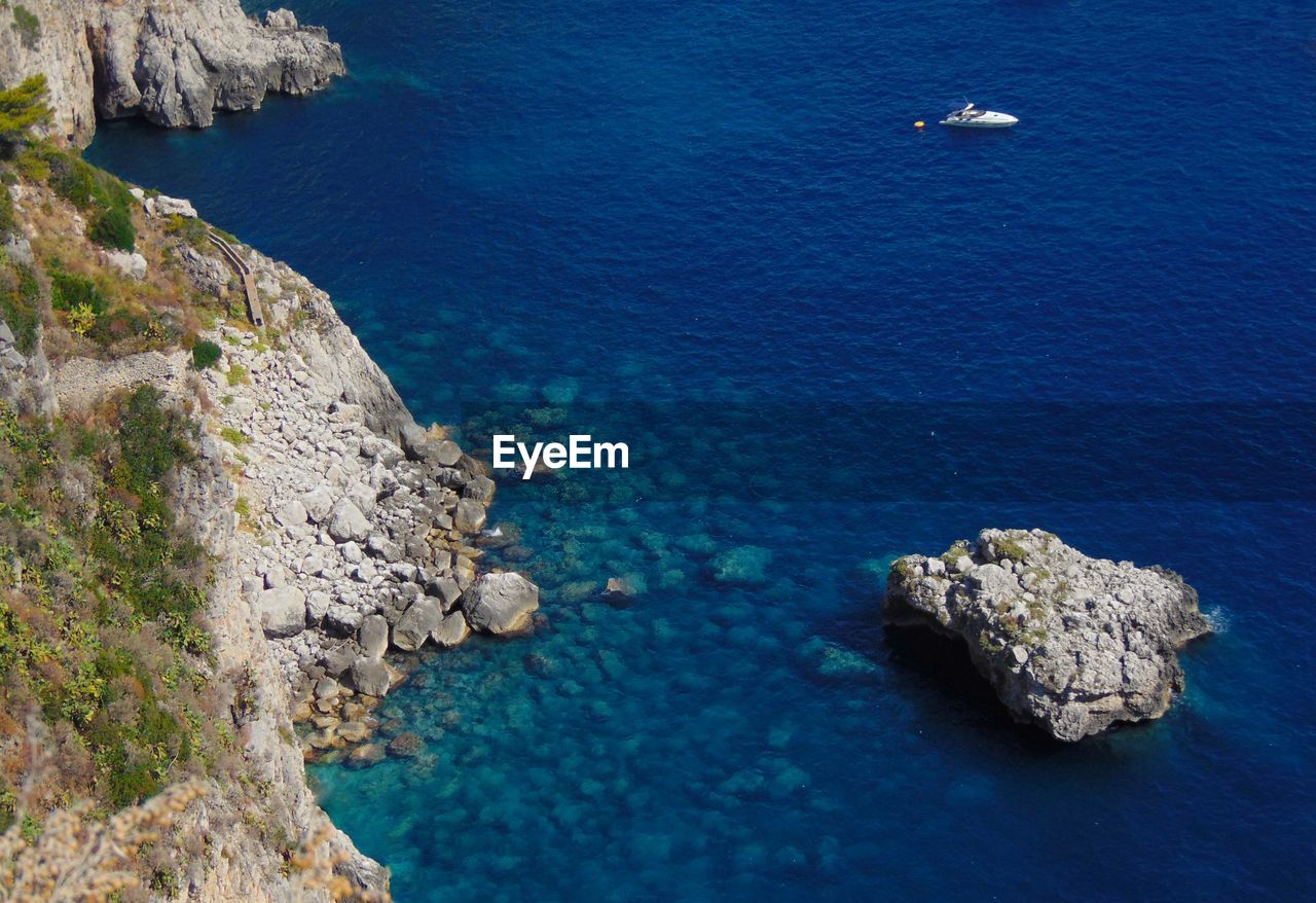 High angle view of rocks by sea