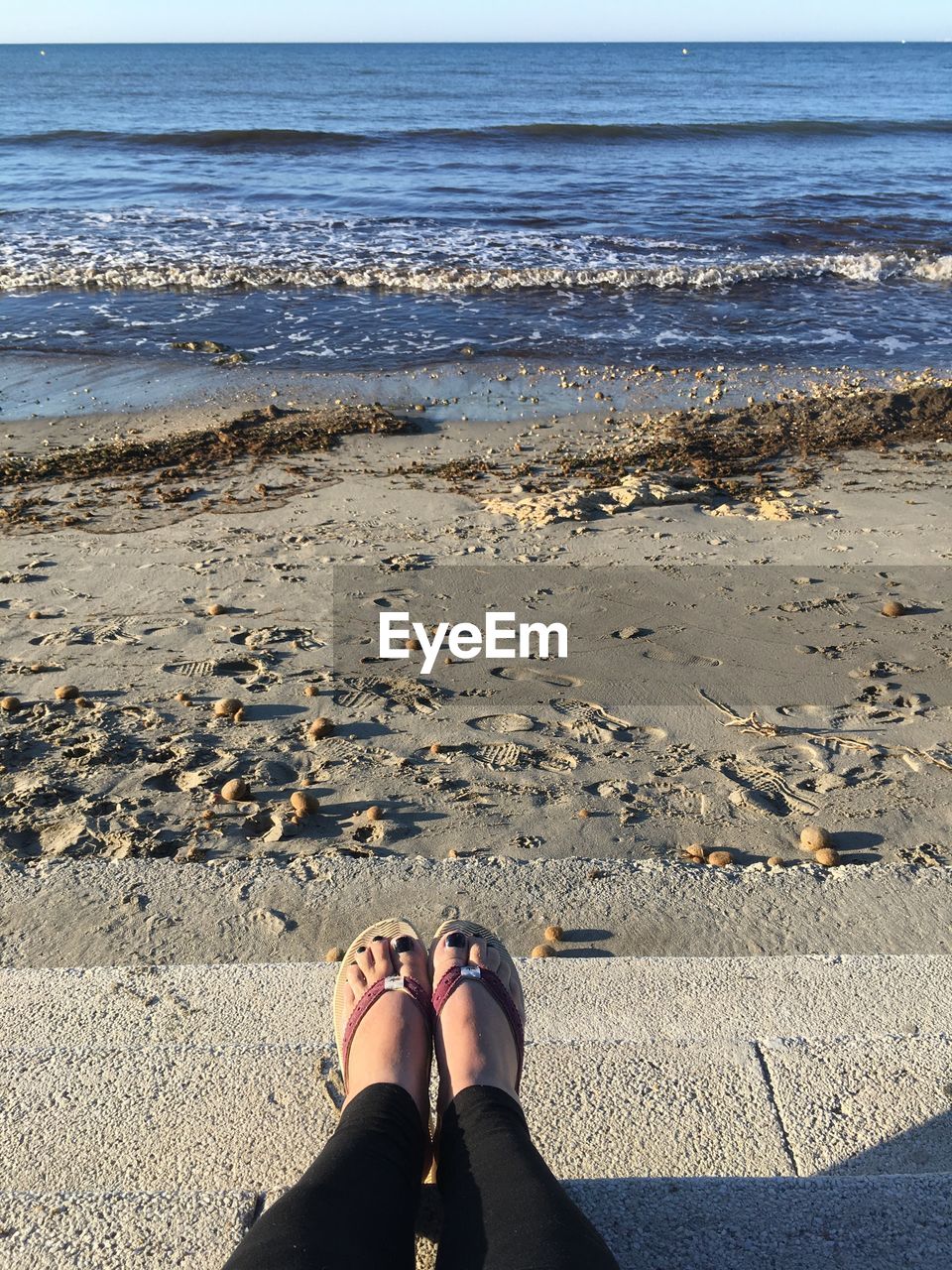 Low section of woman at beach