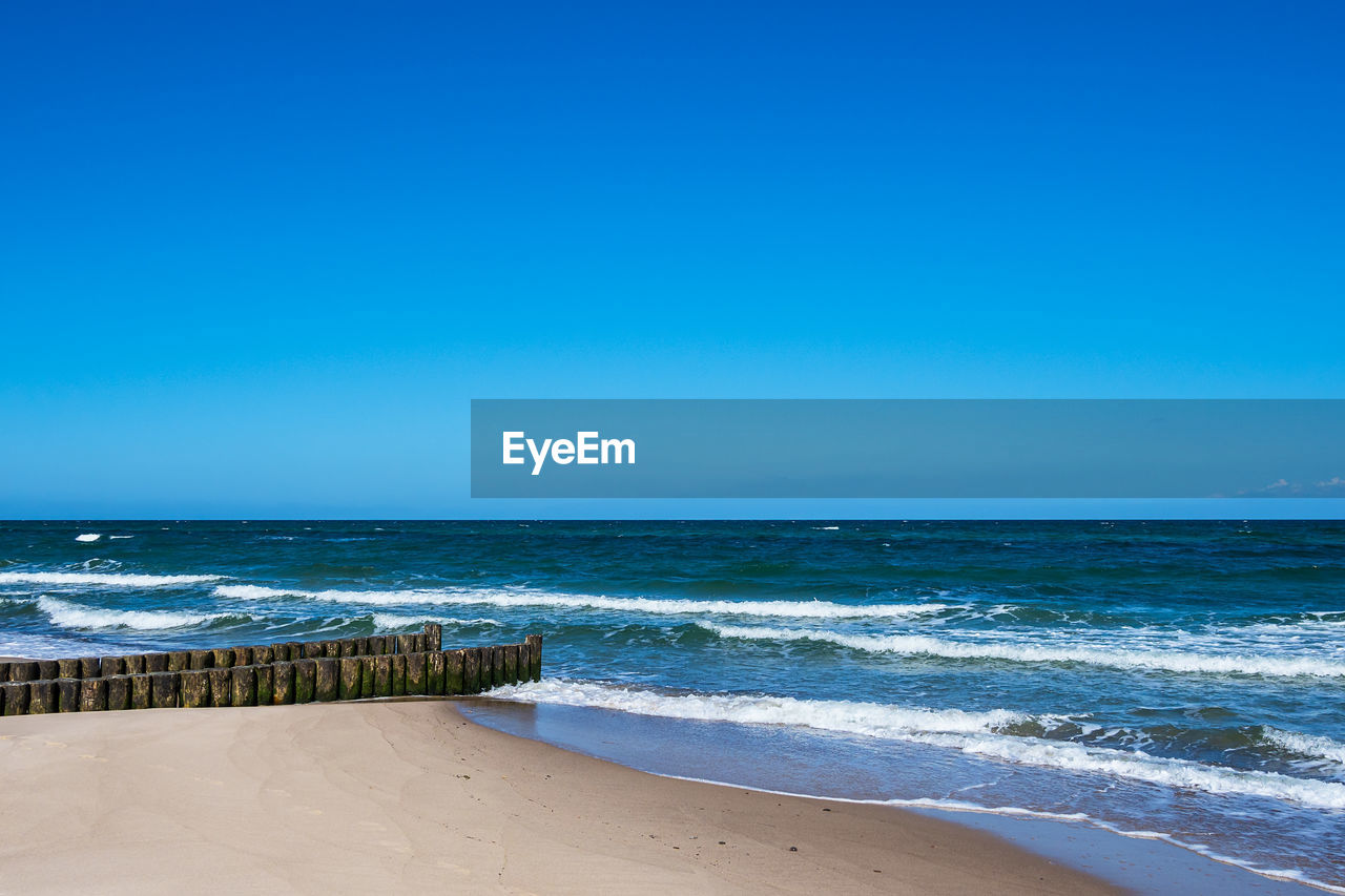 SCENIC VIEW OF BEACH AGAINST CLEAR SKY