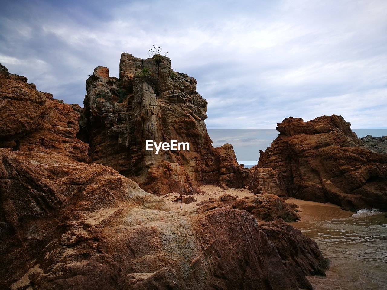 Low angle view of rock formations against sky