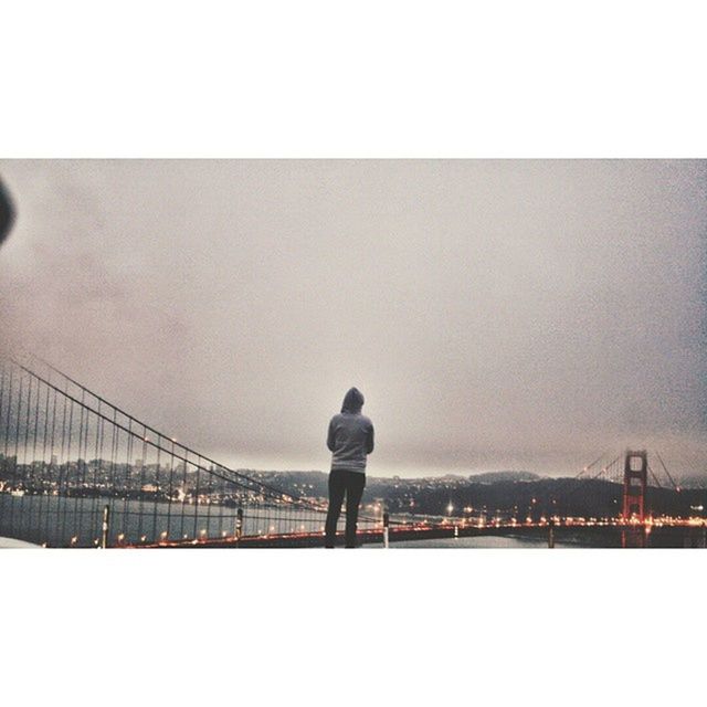 WOMAN STANDING BY RAILING