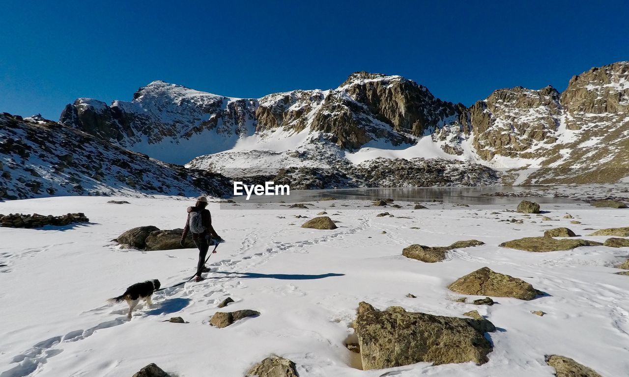 Scenic view of snow covered landscape against blue sky