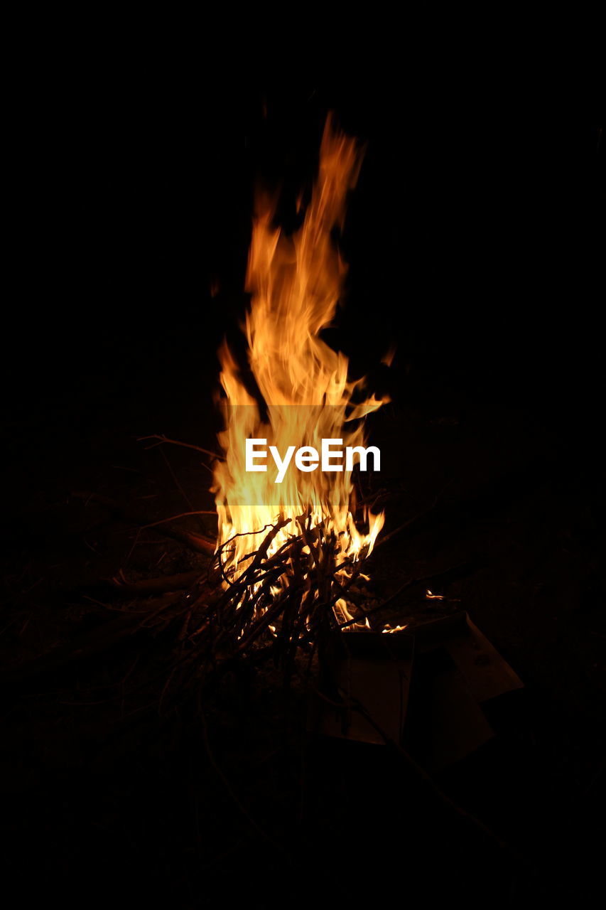 Campfire on field at night