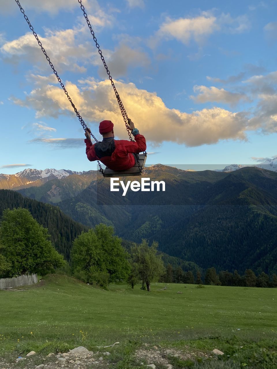 MAN JUMPING ON MOUNTAIN ROAD