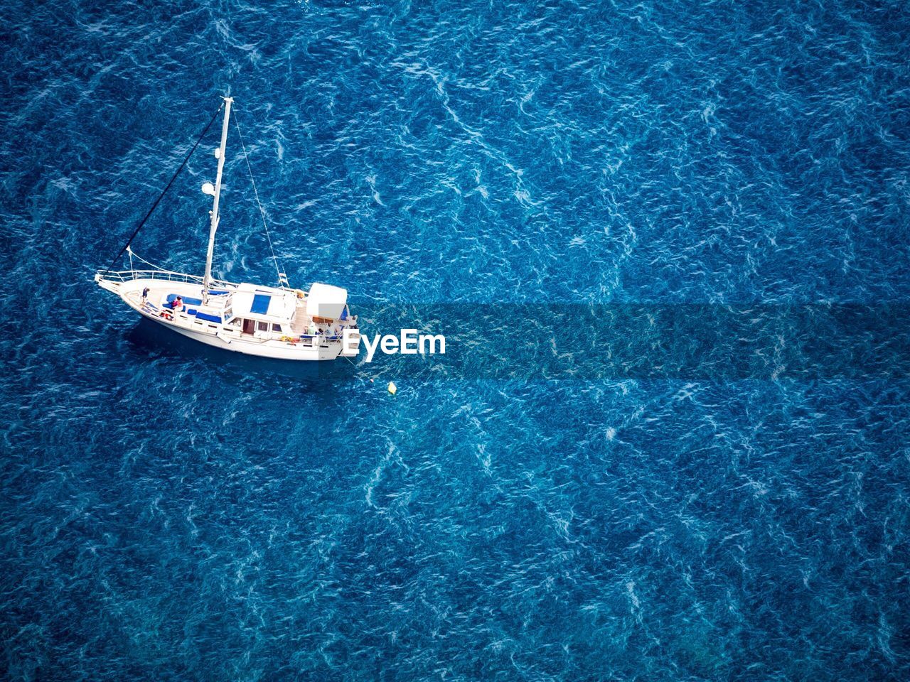 High angle view of boat in calm blue sea