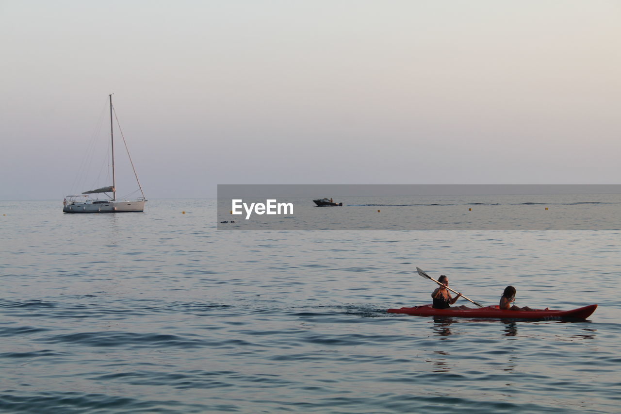 PEOPLE ON BOAT SAILING IN SEA