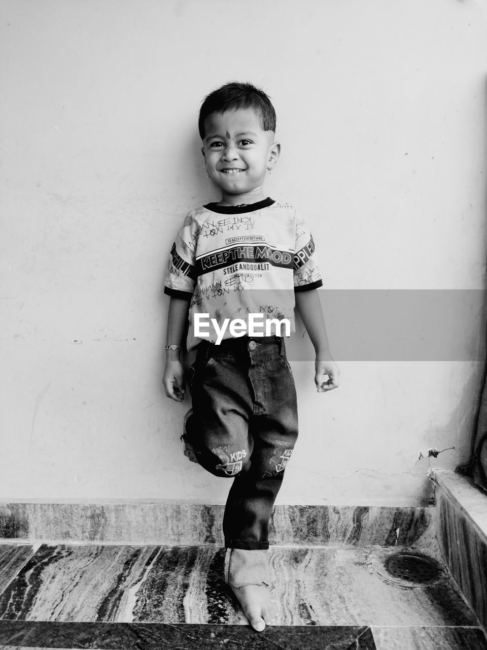 Portrait of smiling boy against wall