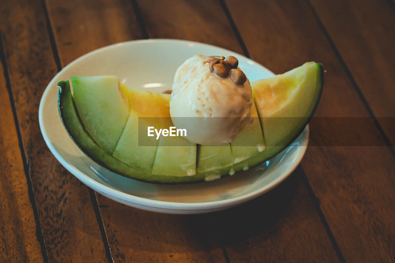 Fruity melon dessert, topped with vanilla ice cream