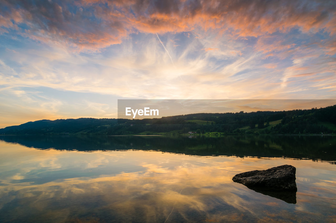 Scenic view of lake against sky during sunset