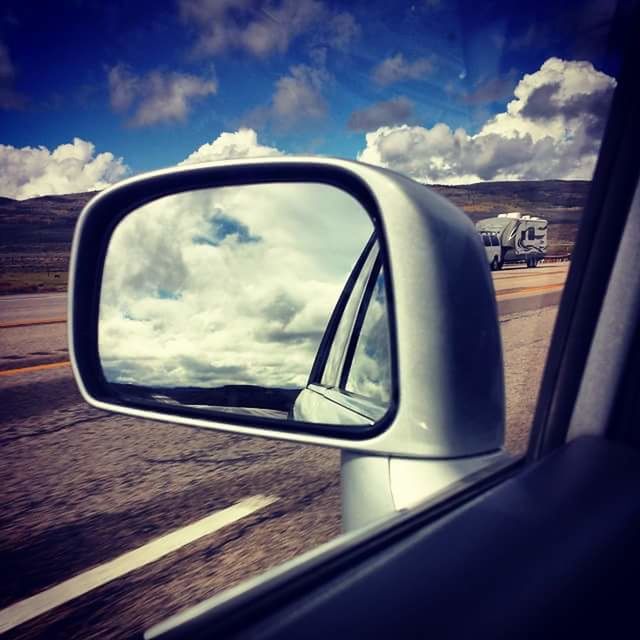 REFLECTION OF CLOUDS IN SIDE-VIEW MIRROR