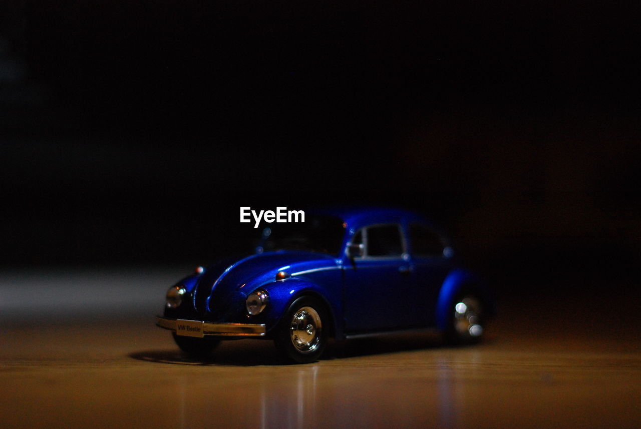 CLOSE-UP OF TOY CAR AGAINST BLUE SKY