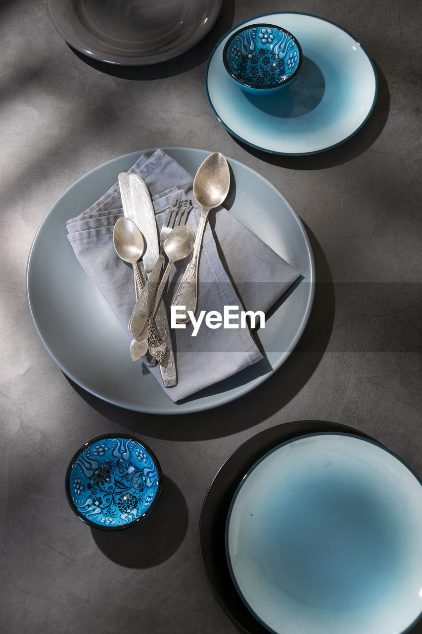 blue, plate, platter, high angle view, food and drink, tableware, dishware, indoors, no people, crockery, studio shot, food, kitchen utensil, ceramic, saucer, table, still life, eating utensil, bowl, circle, household equipment, directly above, spoon, glass