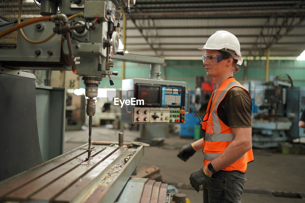 rear view of man working in factory