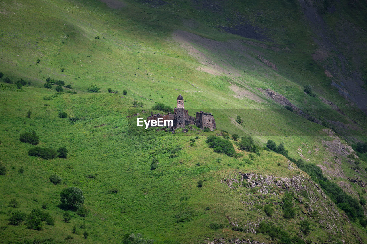 Ancient historical towers in the mountains of chechnya. high angle view of towers on landscape