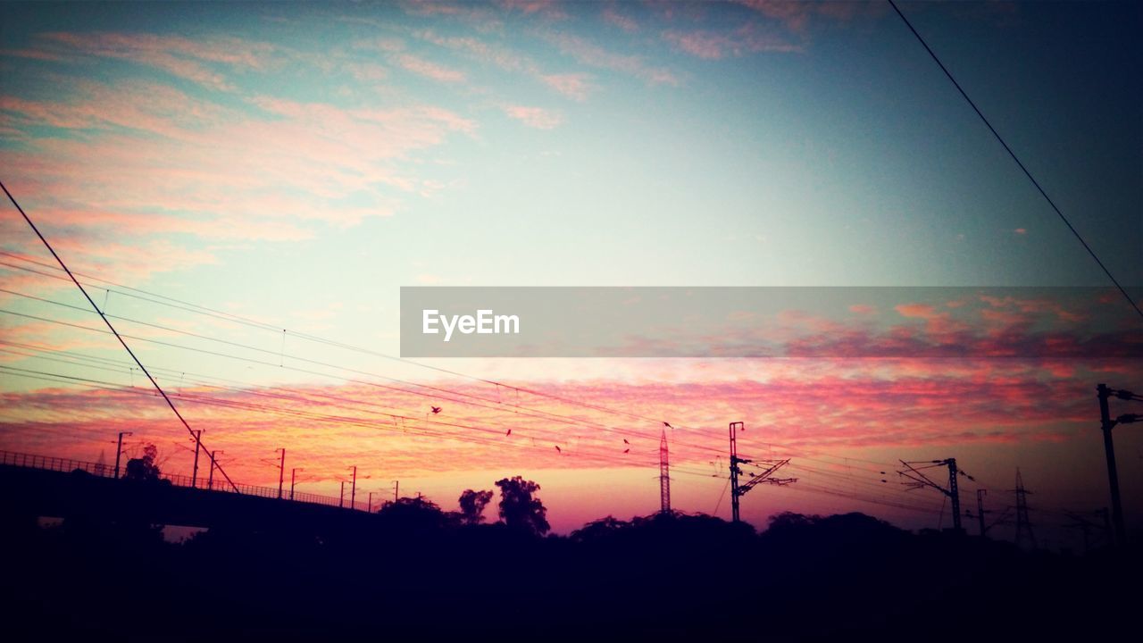 LOW ANGLE VIEW OF ELECTRICITY PYLONS AGAINST SKY