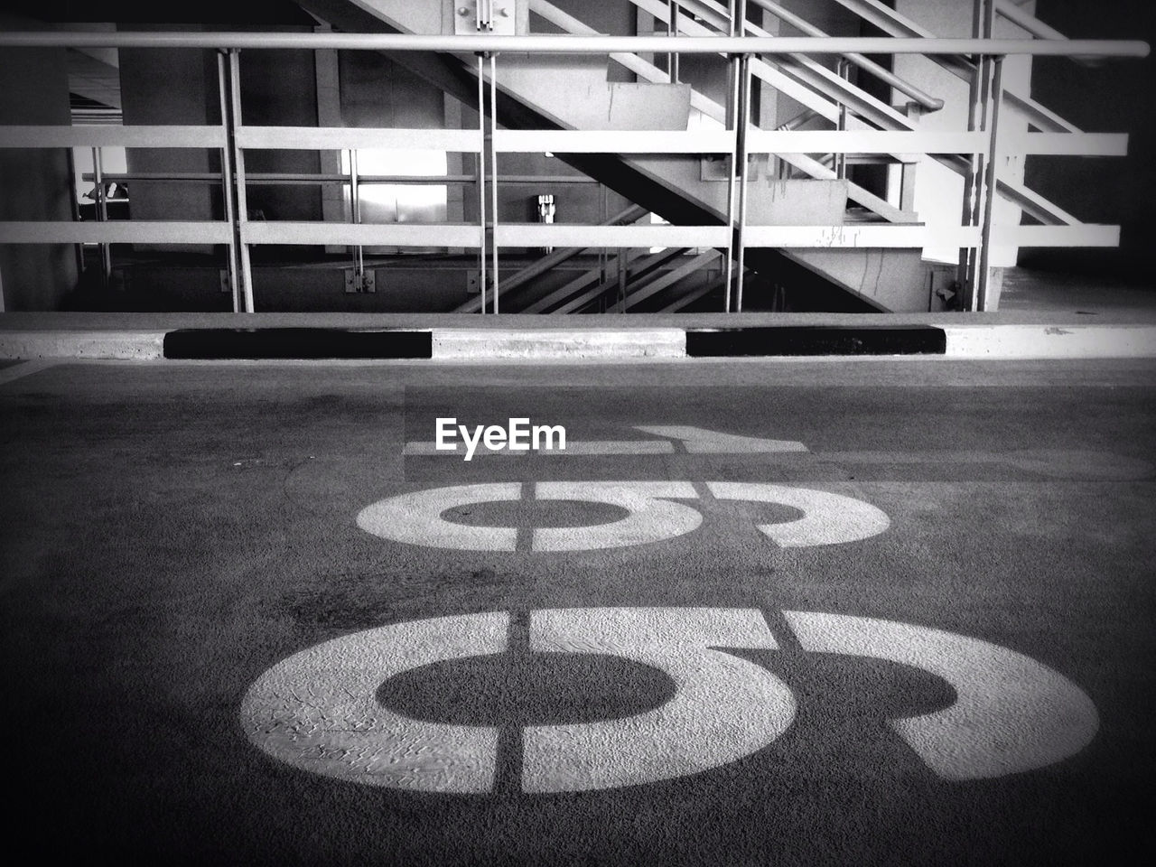 Numbers on floor against railings