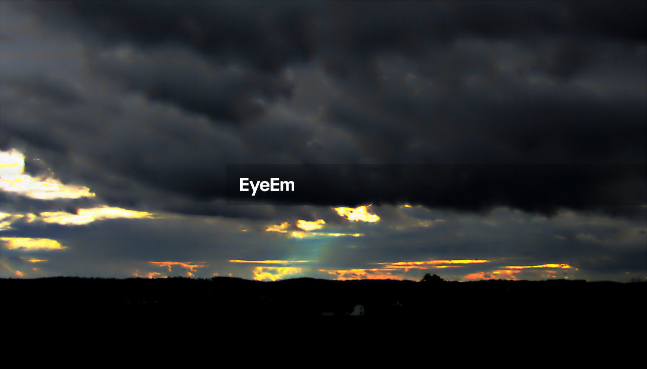 DRAMATIC SKY OVER SILHOUETTE LANDSCAPE