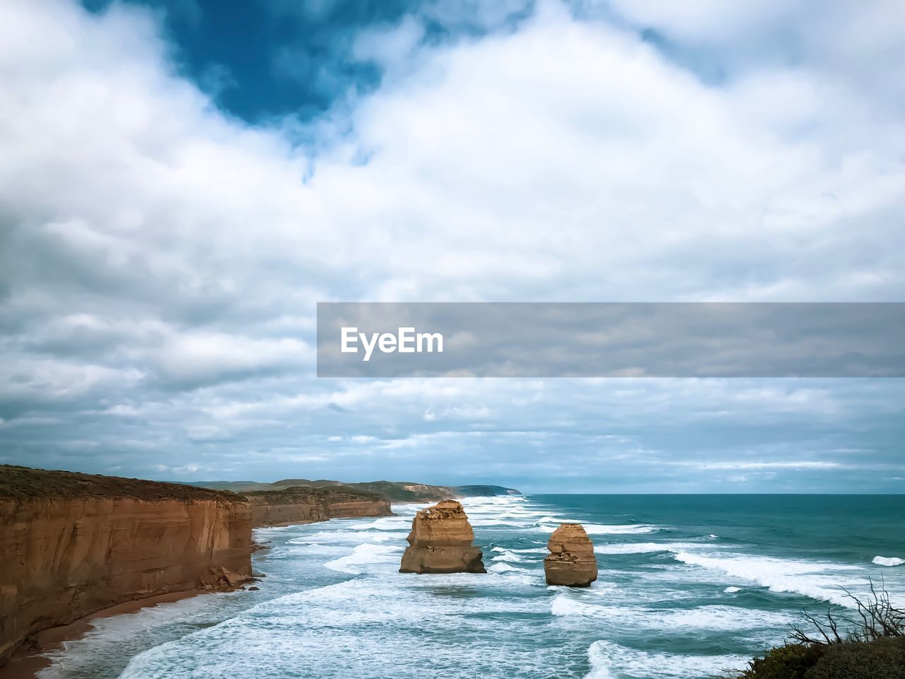 Rocks in sea against sky