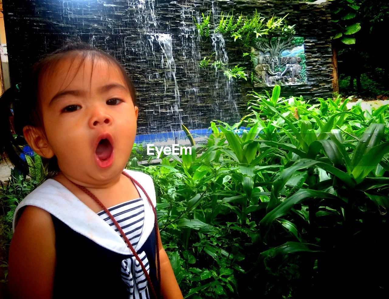 PORTRAIT OF CUTE GIRL IN PLANT