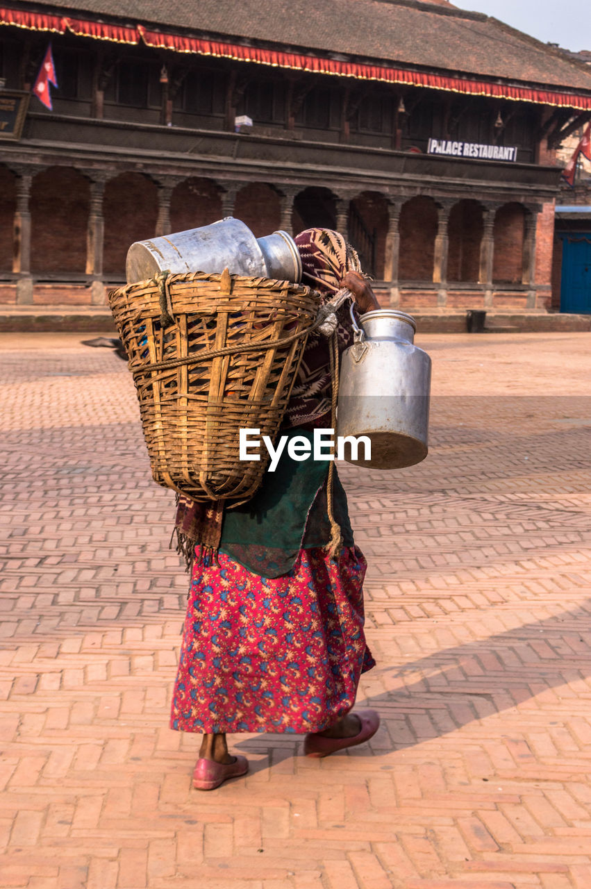 Woman carrying wicker basket