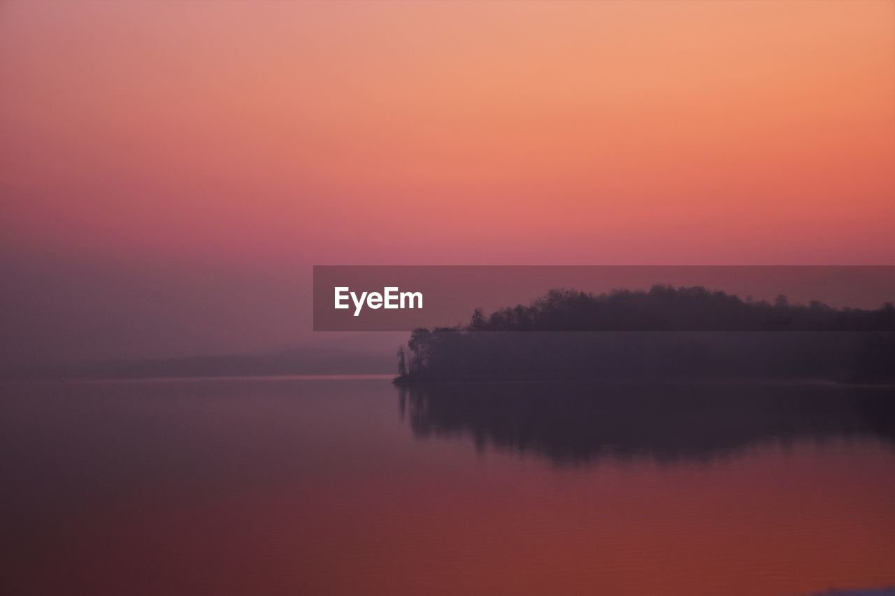 Scenic view of lake against sky during sunset