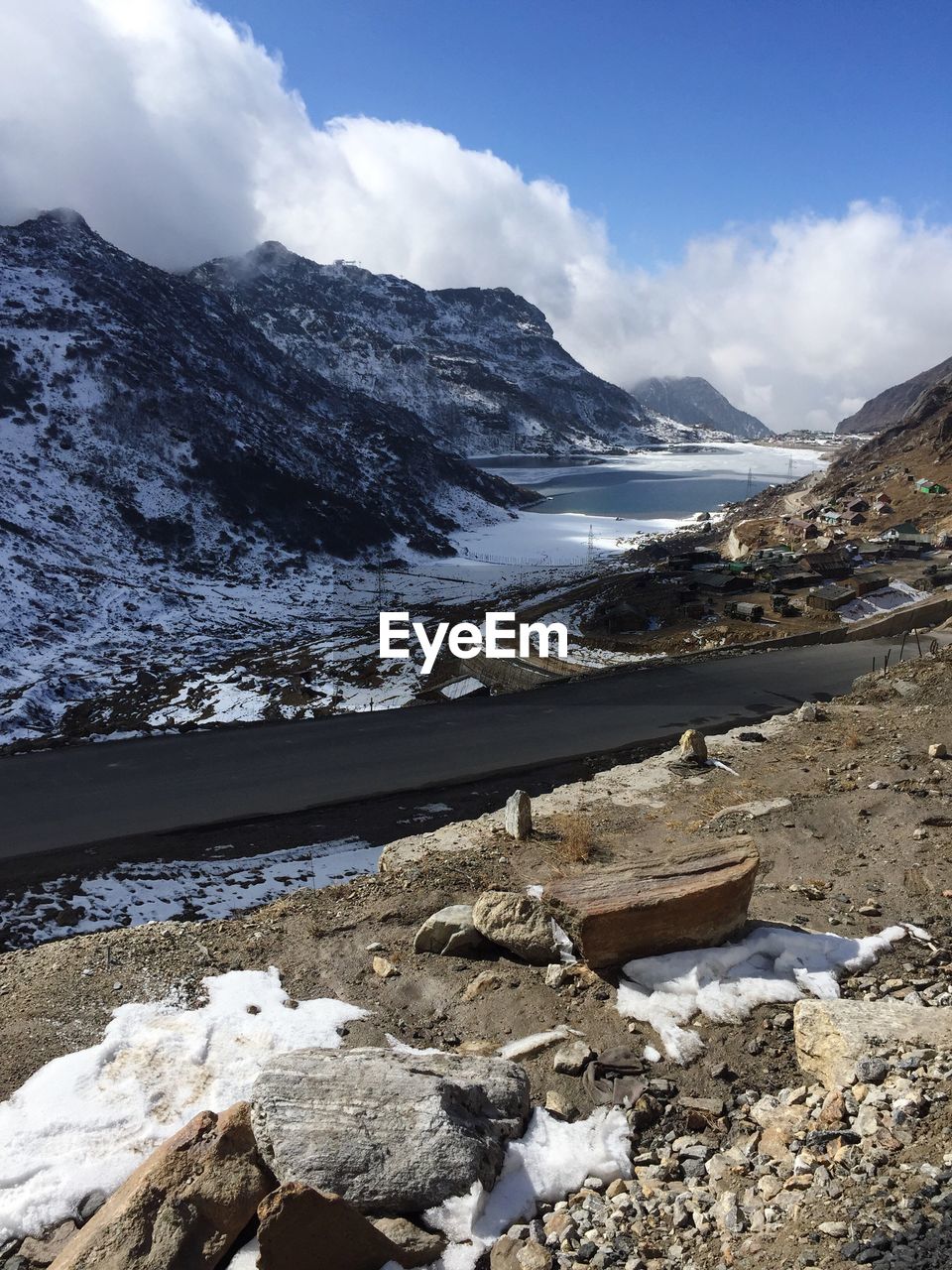 Scenic view of sea and snowcapped mountains against sky