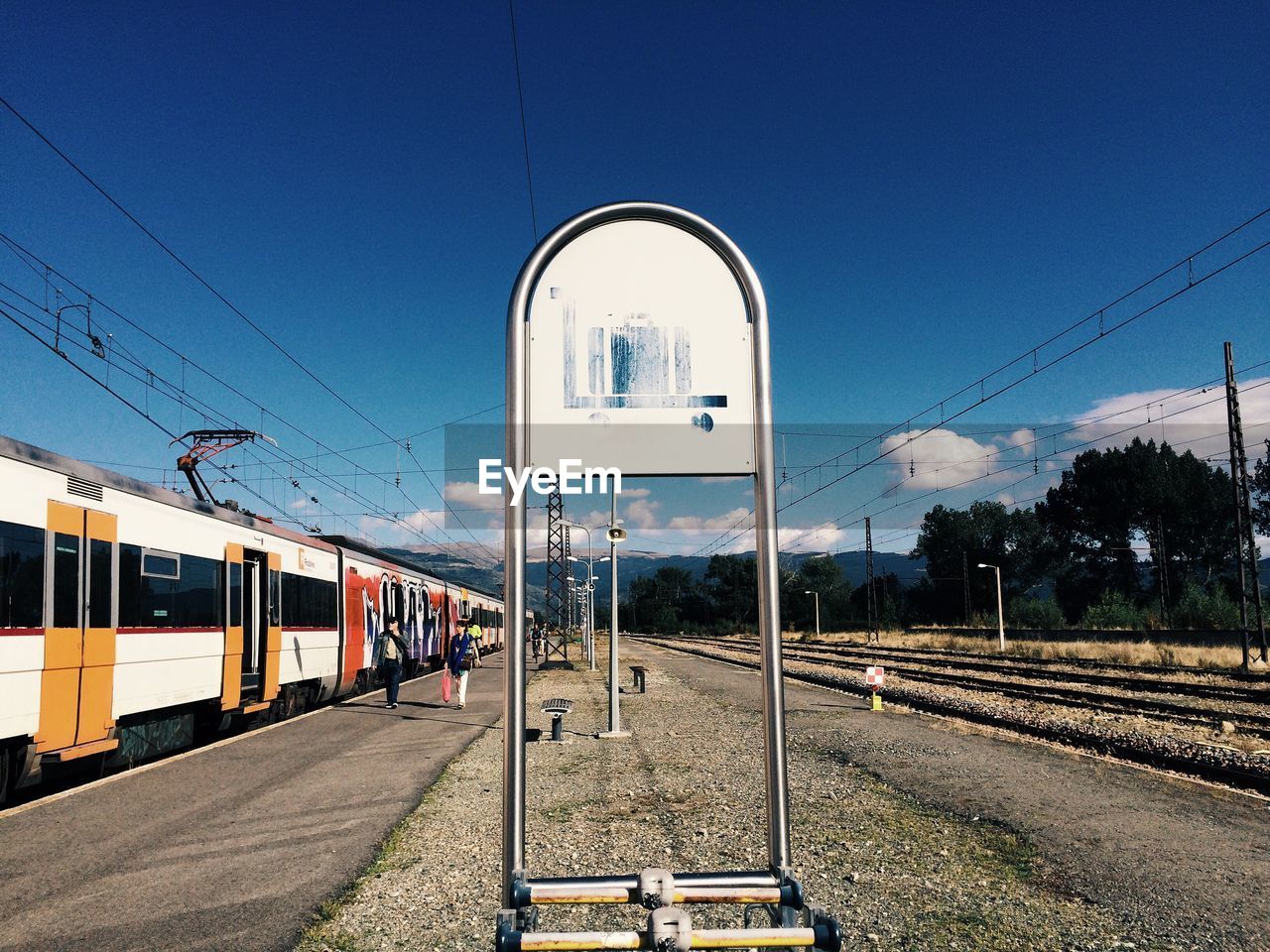 Railroad tracks against blue sky