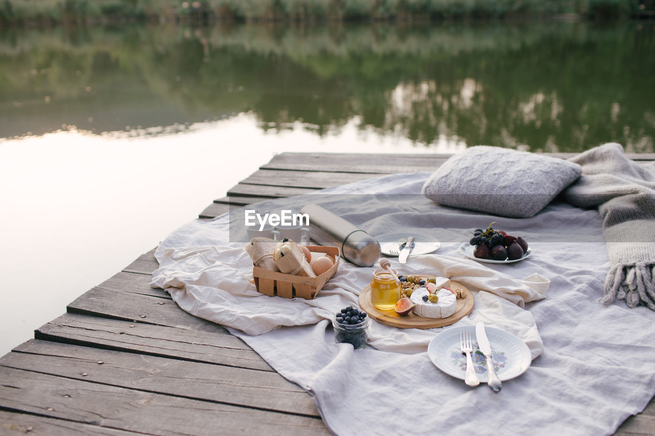 High angle view of food on pier over lake