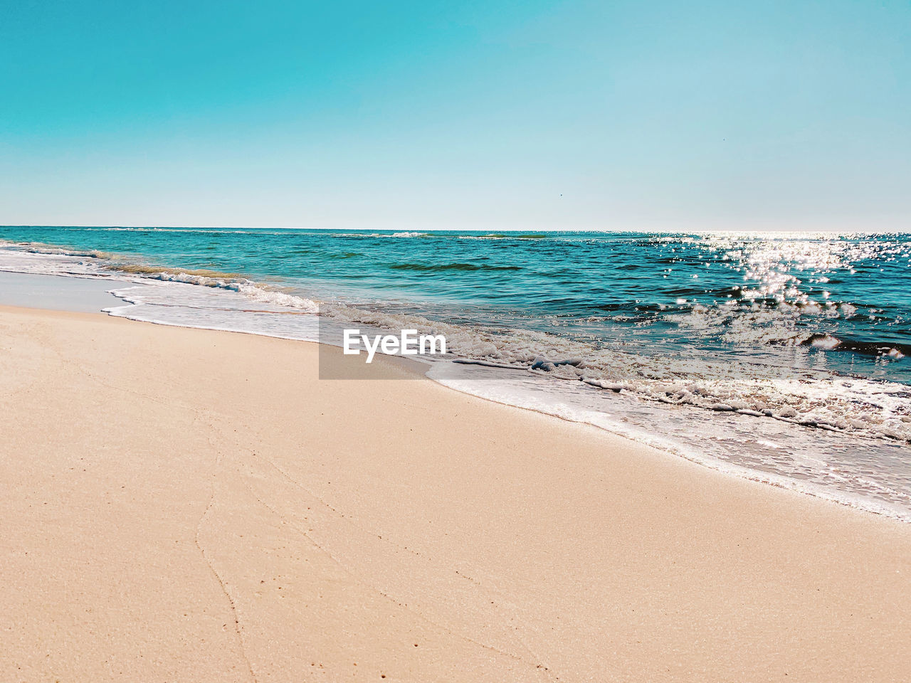 Scenic view of beach against clear sky