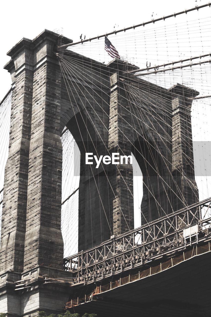 Low angle view of brooklyn bridge against clear sky