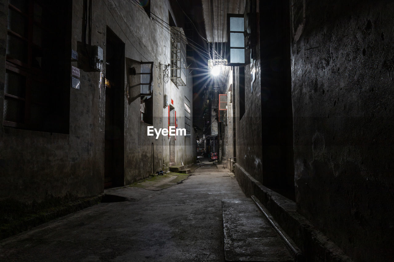 alley, darkness, architecture, road, street, infrastructure, built structure, light, urban area, building, city, building exterior, night, lane, wall - building feature, dark, the way forward, no people, spooky, illuminated, lighting, old, outdoors, lighting equipment, residential district