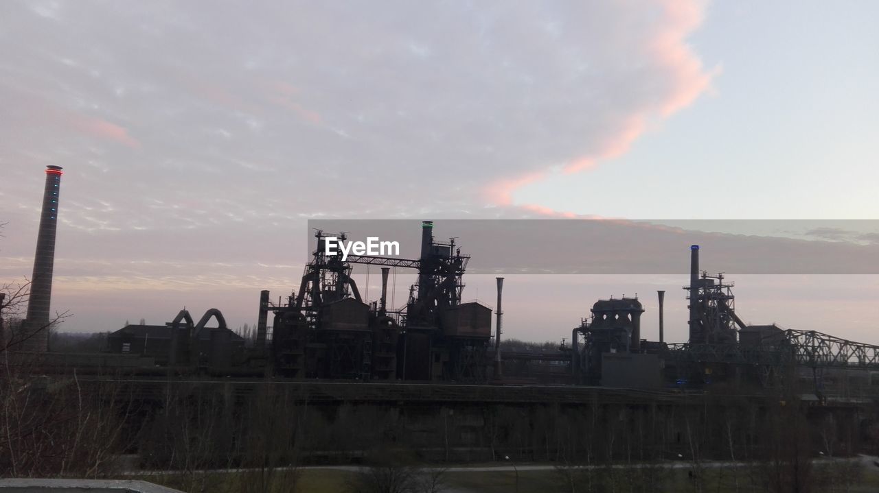 SMOKE STACKS AGAINST SKY